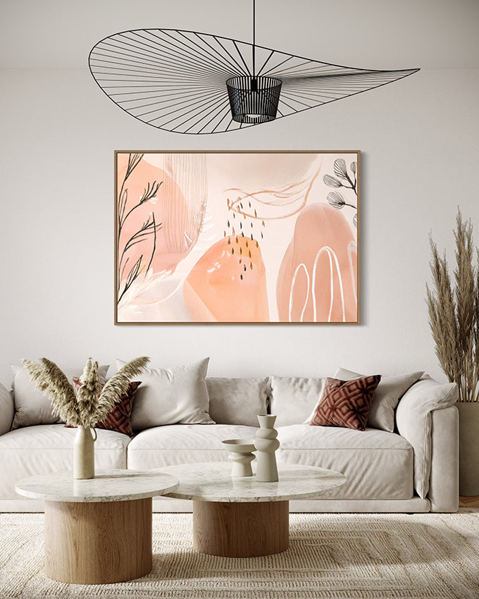 after the rain botanical wall art. soft pastel colours of apricot and blush pink combined with painted leaves and rain drops create a beautiful and unique abstract nature based artwork. artwork is hanging above a lounge in a canvas float frame. artwork is extra large.
