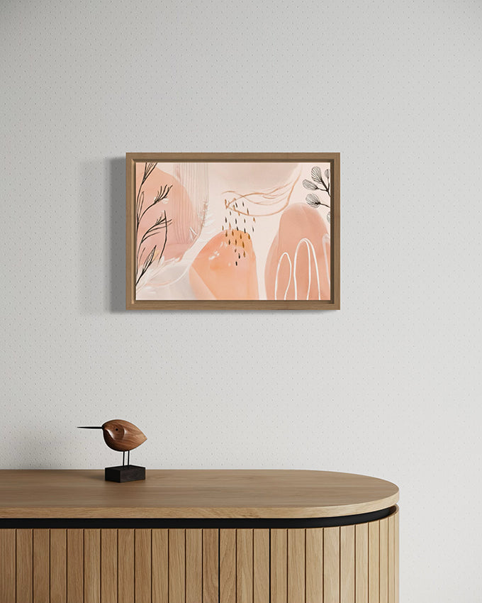 after the rain botanical wall art. soft pastel colours of apricot and blush pink combined with painted leaves and rain drops create a beautiful and unique abstract nature based artwork. artwork is hanging in a high quality canvas timber float frame above a desk