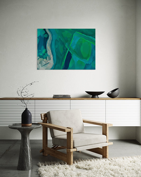 wall art print, artwork depicting an aerial view of the earth as it intersects with rivers and estuaries. Artwork has greens and blues in varying tones. Artwork hanging in living room.