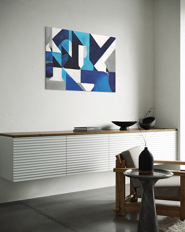 Abstract contemporary printable wall art with navy blue, blue, grey and white tones. wall art hanging in living room above a low lying cupboard.