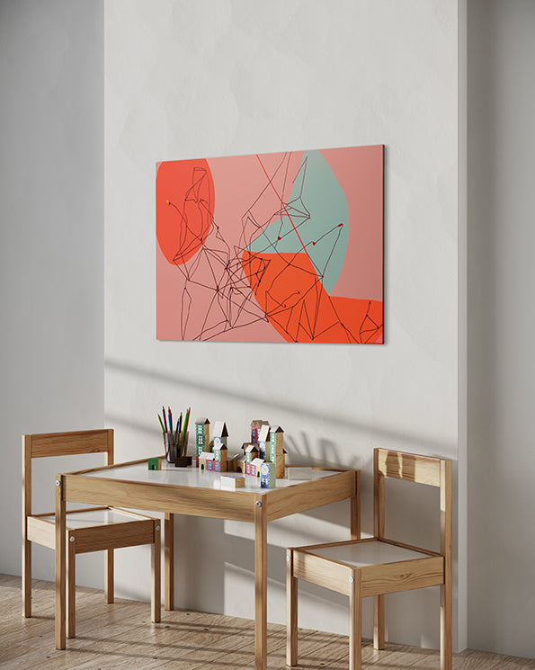printable wall art, red, pink and a muted blue colours with a line drawing over the top create a unique printable artwork, hanging in a child's room above a drawing table.