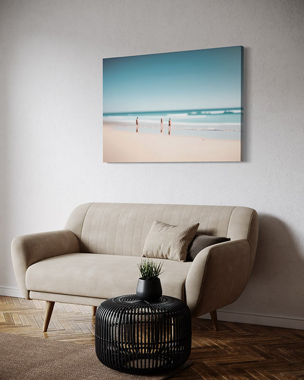 Beach Day a unique wall art print featuring a blurred beach scene. Waves crash whilst people watch from the sand. Wall art print in living room above lounge.