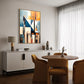 Abstract wall art print with geometric shapes in blue, orange, and grey. Artwork is hanging in a canvas float frame in a modern living room