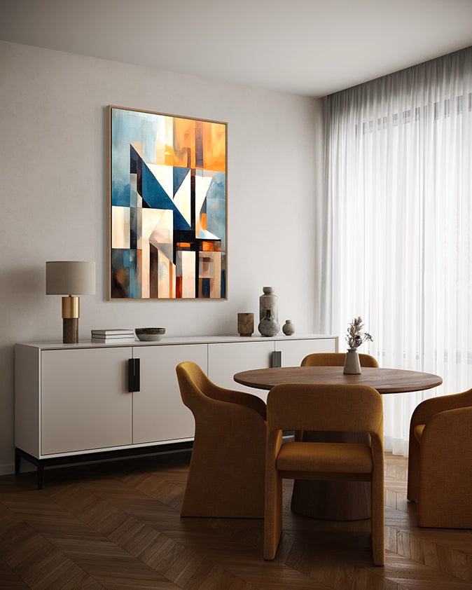 Abstract wall art print with geometric shapes in blue, orange, and grey. Artwork is hanging in a canvas float frame in a modern living room