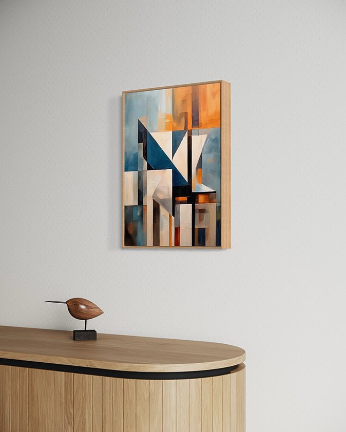 Abstract wall art print with geometric shapes in blue, orange, and grey. Artwork is hanging in a canvas float frame in a modern living room. 