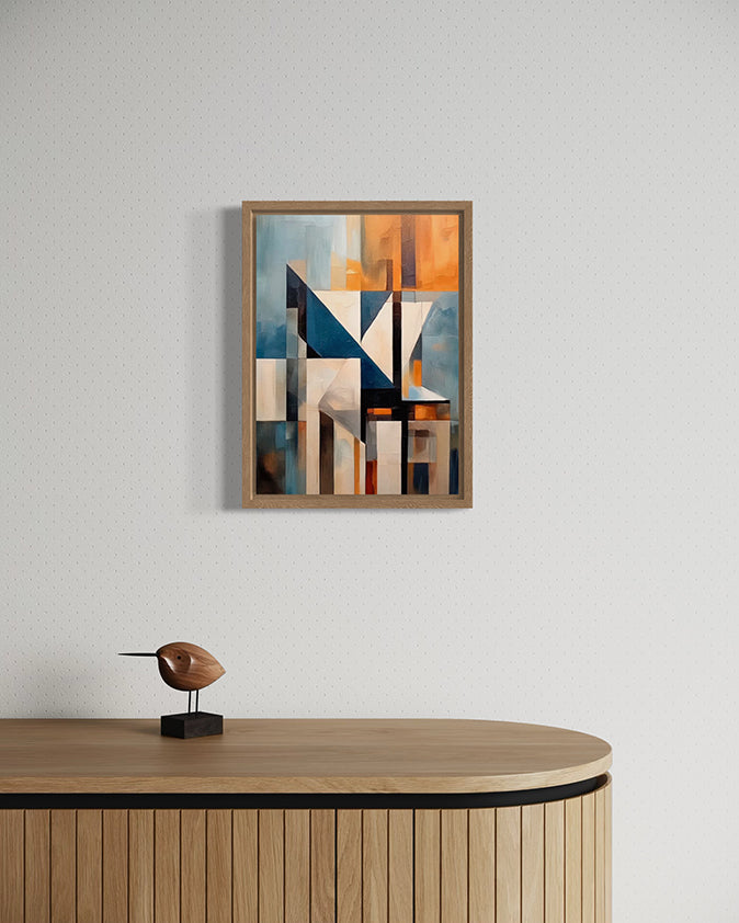 Abstract art piece in a wooden canvas float frame on a wall above a wooden cabinet with a sculpture.