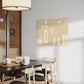abstract artwork, plan beige background with cream coloured shapes and pine cone like figures is how I would describe the wall art which is hanging in a living room above a dining table