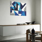 Abstract contemporary printable wall art with navy blue, blue, grey and white tones.  wall art hanging in living room above a low lying cupboard.