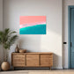 abstract artwork featuring ocean shoreline from above, pink sand meets the white wash in the middle of the frame with blue ocean waves, wall art print hanging in living room above side board