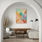 abstract artwork, pastel rainbow colours in geometric shapes, wall art print hanging in living room in a timber frame