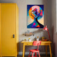 abstract artwork featuring human head and tree simultaneously fully of blood and bright colours.  Abstract artwork is hanging in a kids room next to a bright yellow cupboard and above a bright yellow drawing table.