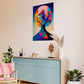 abstract artwork featuring human head and tree simultaneously fully of blood and bright colours. Abstract artwork is hanging on living room wall above a low lying cabinet.