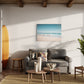 Beach Day a unique wall art print featuring a blurred beach scene.  Waves crash whilst people watch from the sand.  Wall art print hanging in living room.