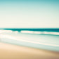Beach Walk unique wall art print.  Two figures in red are off in the distance with a blurred ocean scene creating a peaceful print. 