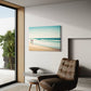 Beach Walk unique wall art print.  Two figures in red are off in the distance with a blurred ocean scene creating a peaceful print. artwork in living room hanging next to a window and above a chair.