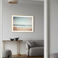 Joyful moments unique wall art print with muted beach scene with children running on the waters edge. art print hanging in living room.