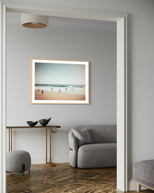 Joyful moments unique wall art print with muted beach scene with children running on the waters edge. art print hanging in living room.