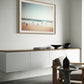 Joyful moments unique wall art print with muted beach scene with children running on the waters edge. wall art print hanging in living room.