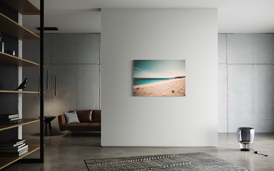Shell Cove unique wall art print, blurred shoreline with shells and aqua water against a soft blue sky.  wall art print in a modern living room.