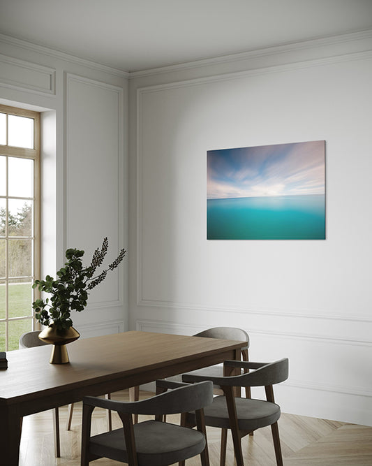 unique wall art print, soothing horizon is a coastal abstract artwork featuring a gorgeous blue horizon. wall art print hanging in living room above a dining table.