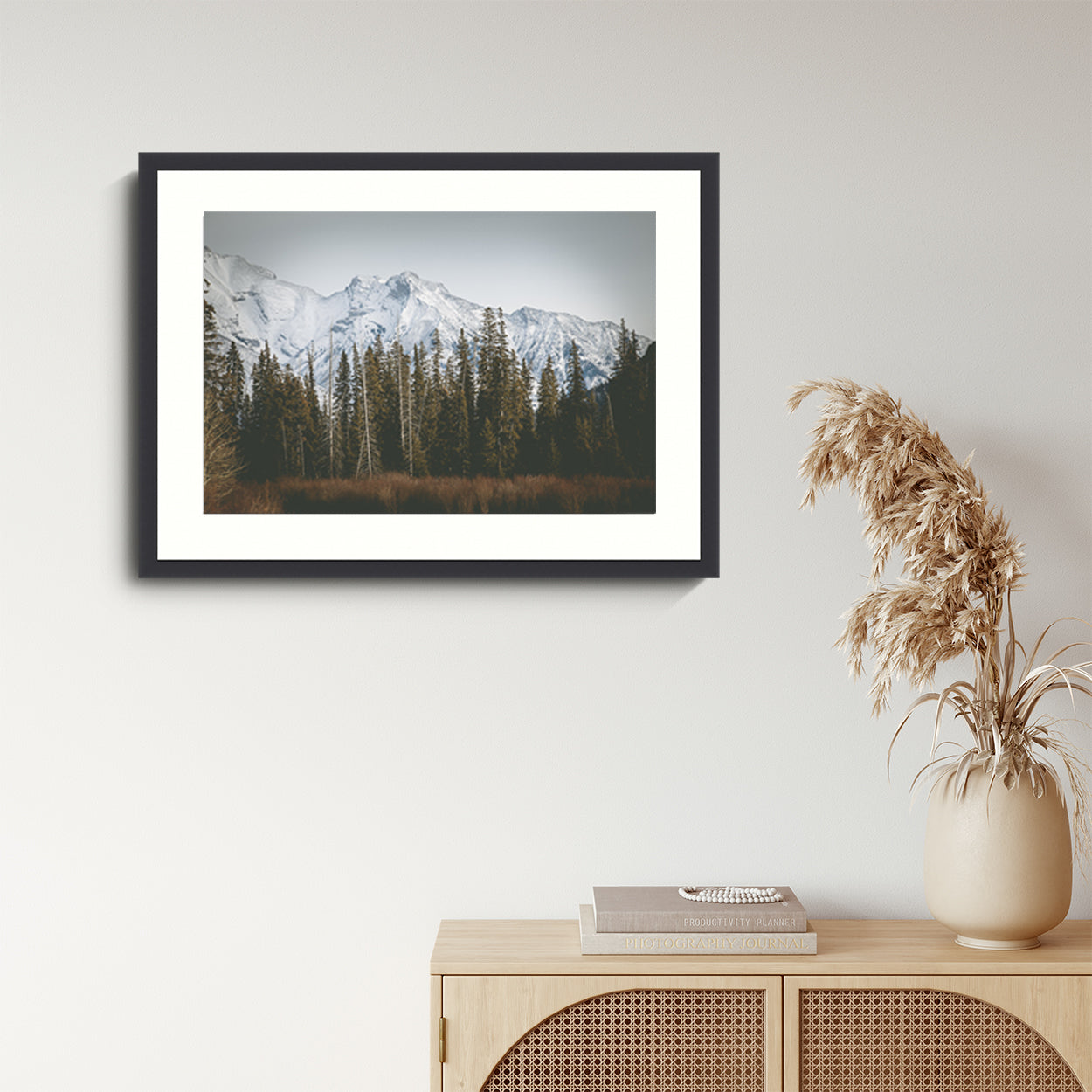 Landscape Photography Wall Art Print, snow capped mountains and pine trees nature photography in a black frame.  Wall Art in living room