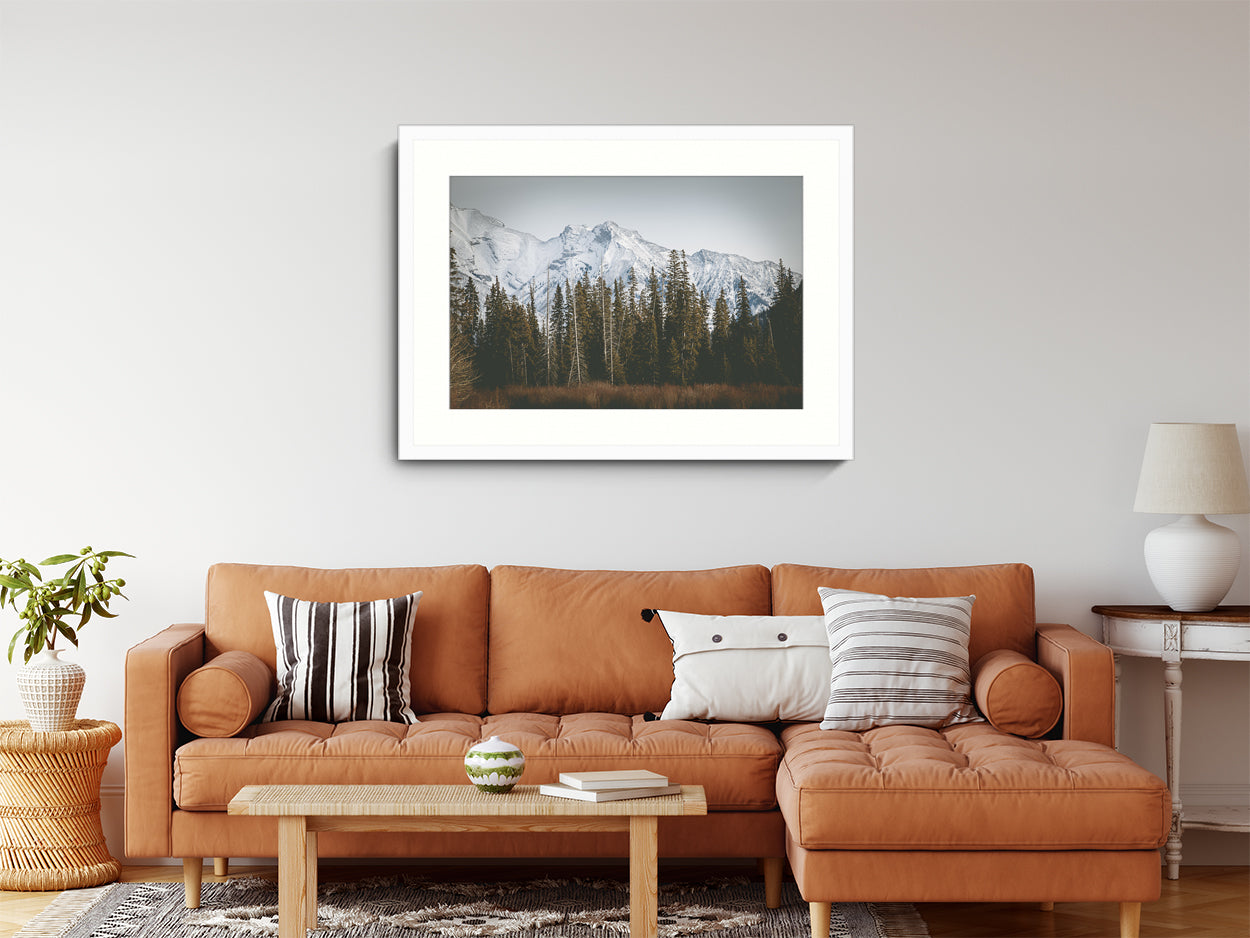 Landscape Photography Wall Art Print, snow capped mountains and pine trees nature photography in a white frame.  Wall Art in living room
